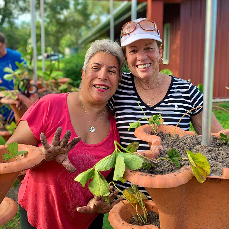 two happy women gardening