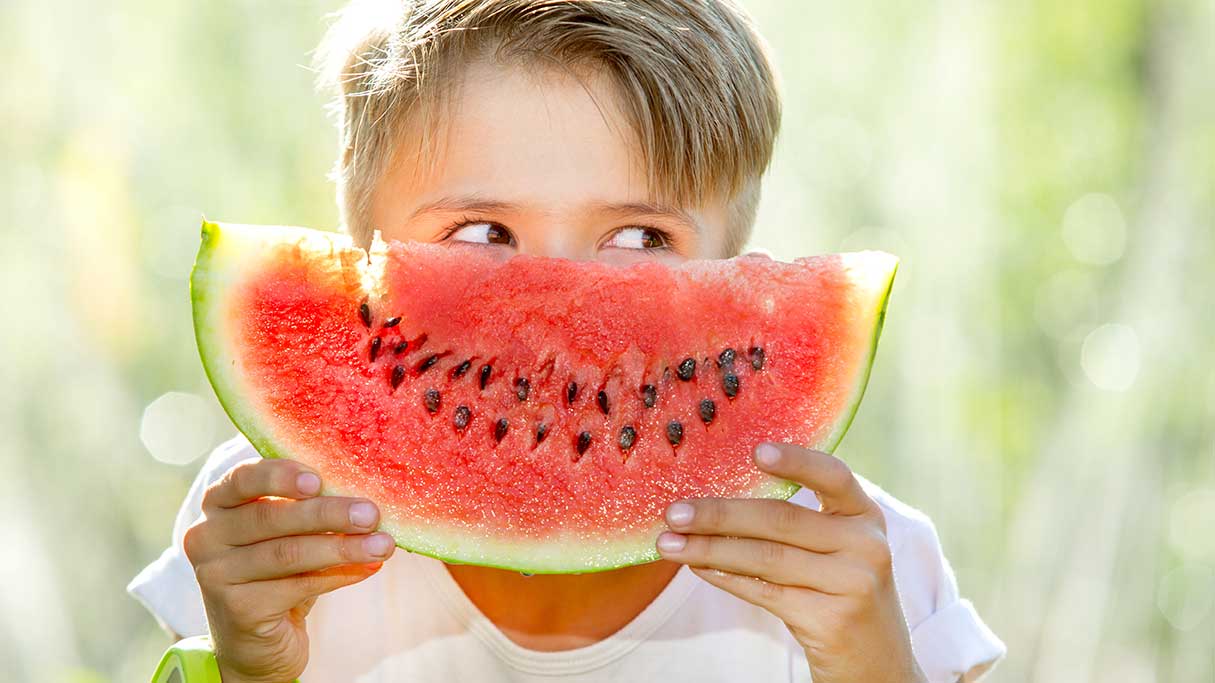 happy child eating watermelon
